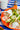 Romige zelfgemaakte ranch dressing wordt met een lepel over de zalm en asperges verdeeld.